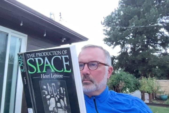 Image: the author at home reading a book